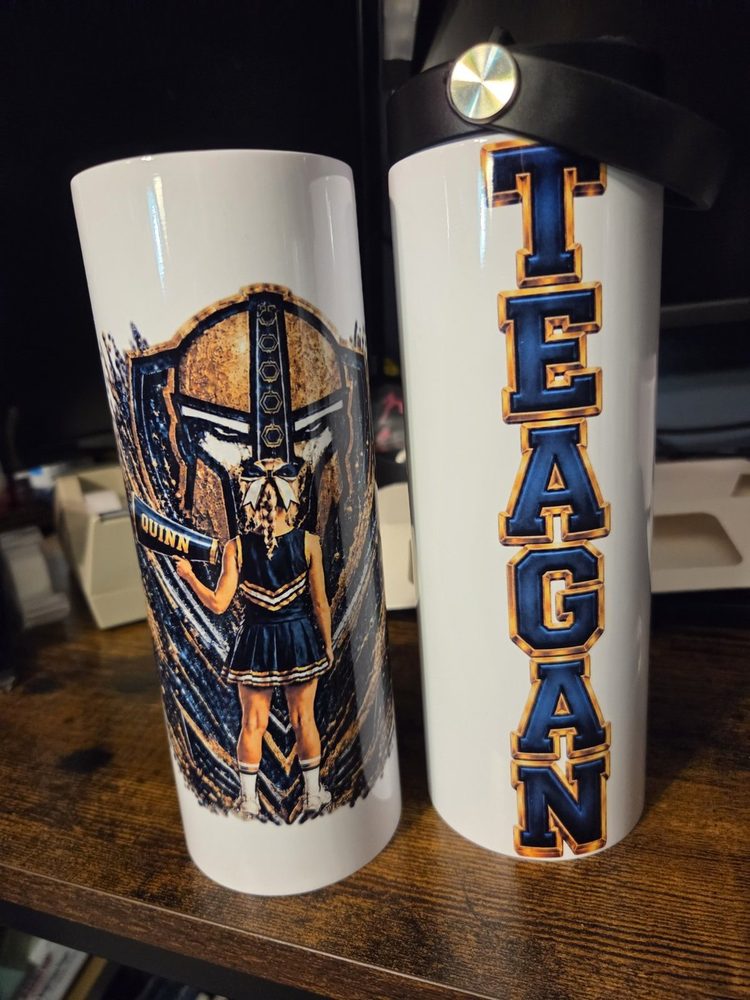 Custom Quinn and Teagan cheer tumblers in navy and gold.